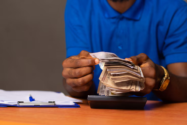 nigerian-man-counting-some-money_216356-626